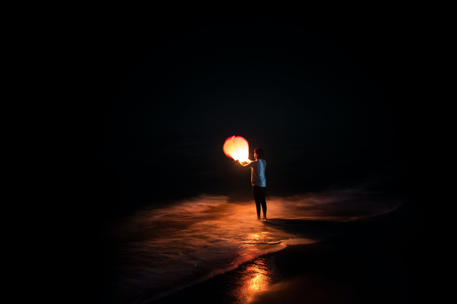 light sleep light sleeper person standing on shore holding brown paper lantern